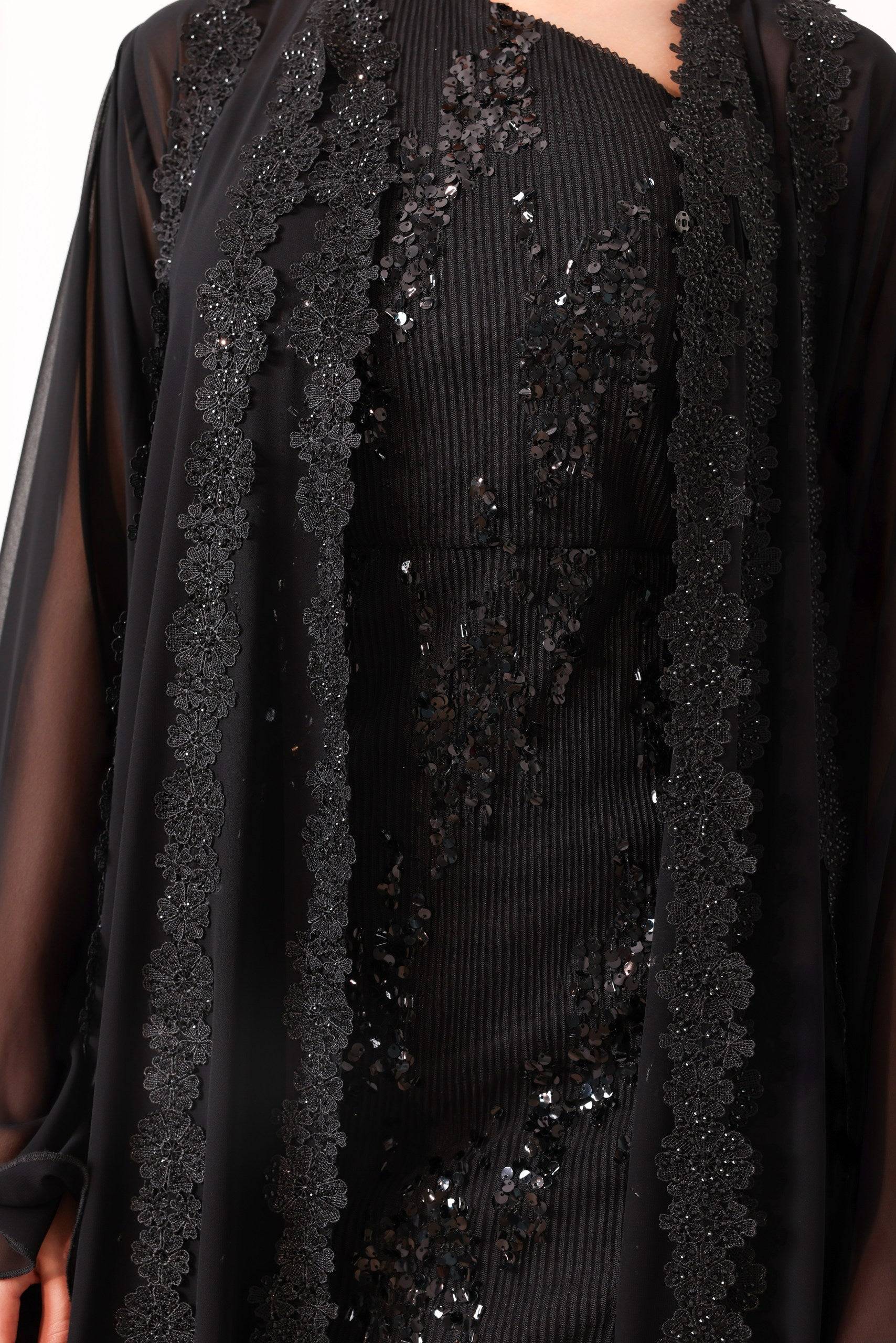 Close-up of Sahara Shimmer black embroidered abaya showcasing intricate floral detailing and sheer fabric for an elegant, chic look.